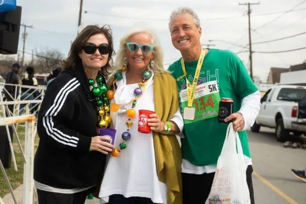 Three friends with beads and a finisher medal